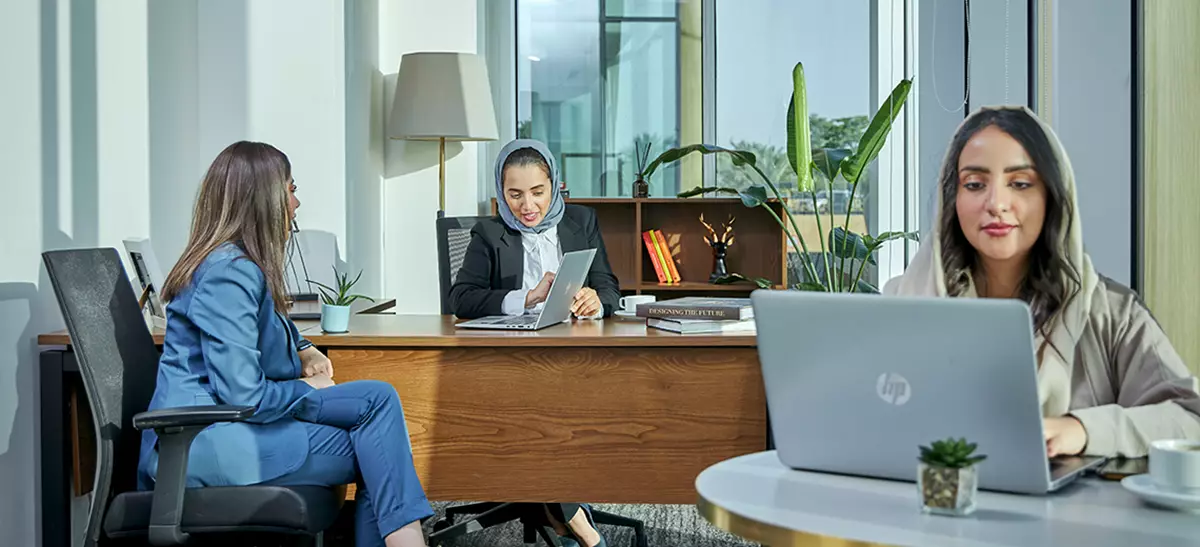 Clients brainstorming in a fully equipped serviced office with a city view.