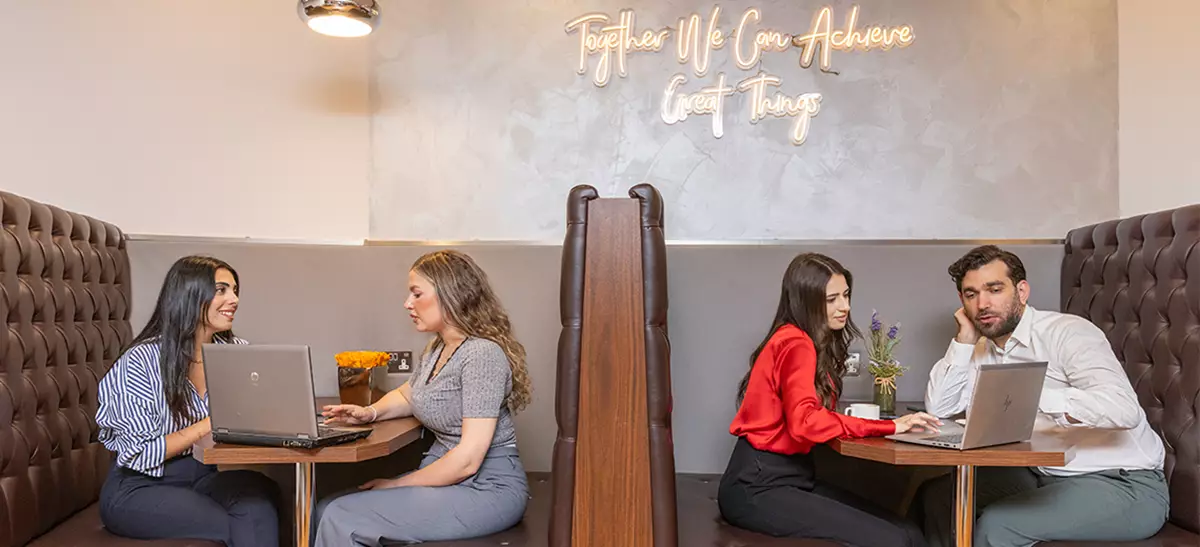 Clients working in a 5-star coworking space with hot desks, collaboration booths, and spacious corridors.