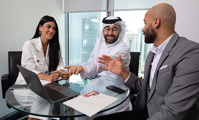 Client collaborating in a fully equipped meeting room with a stunning city view at Tornado Tower.